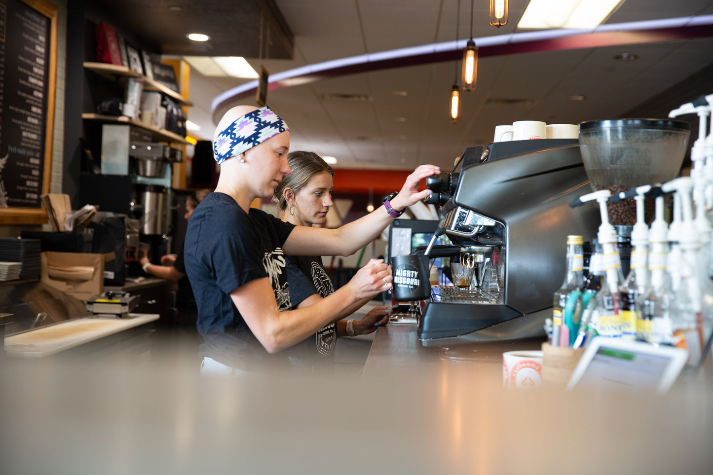 Mighty Missouri Coffee Baristas steaming milk on espresso machine at Bismarck YMCA Mighty Missouri Coffee location.