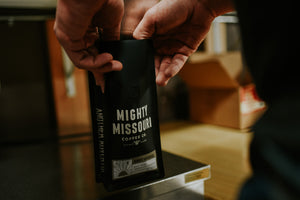 Mighty Missouri 12 oz. coffee bag being filled with roasted coffee